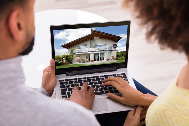 Couple looking at house on laptop
